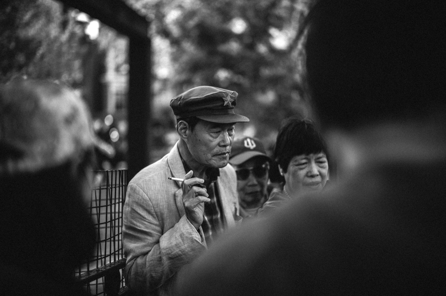 The Smoker in the Crowd. New York, Chinatown.